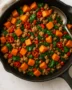 Spicy ground turkey and sweet potato skillet in a cast-iron pan with herbs and lime