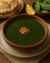 “Authentic Egyptian Molokhia served with rice and roasted chicken on a traditional table setting.”