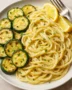 Recipe card showing creamy lemon garlic pasta with roasted zucchini and fresh parsley garnish